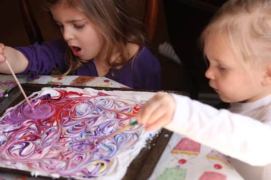 preschoolers making marbled paper with shaving cream and food colouring