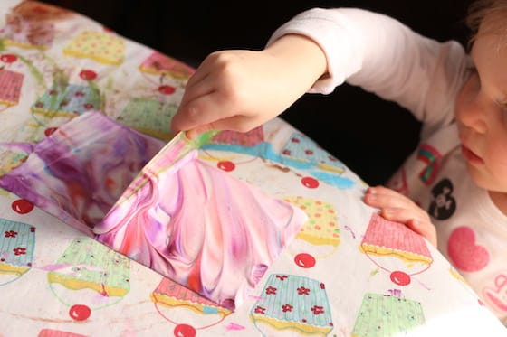 scraping shaving cream off to reveal marbled paper 