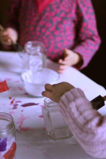 preschoolers brushing mod podge on jars