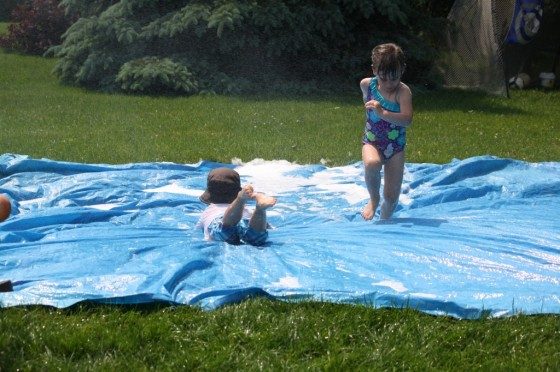 preschoolers on diy slip and slide