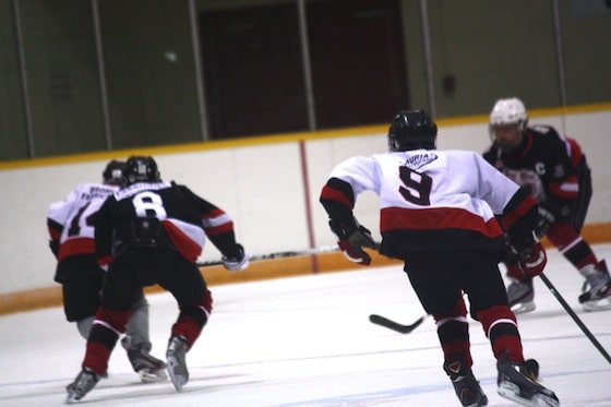 hockey players skating up the ice