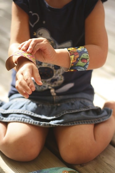 child putting on two duct tape bracelets