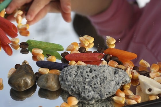 small hands experience sensory play on a mirror