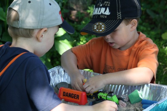 Two Boys playing with construction sensory bin