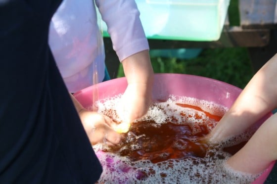 kids playing with bowl of coloured water