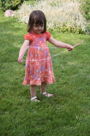 Toddler holding homemade giant bubble wand 