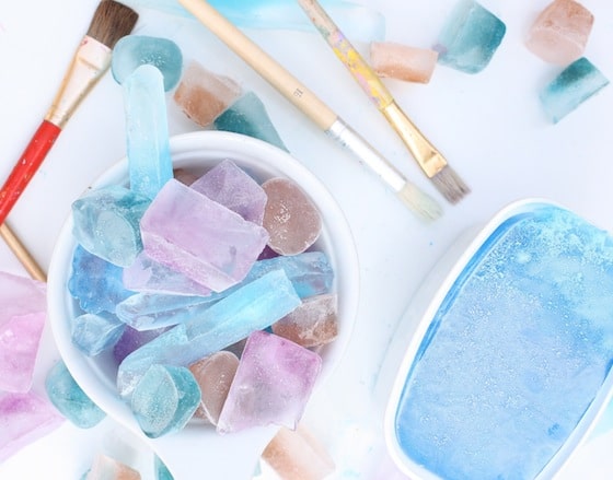 Coloured ice cubes, paint brushes for science activity with kids