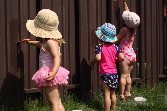 kids painting the fence with water