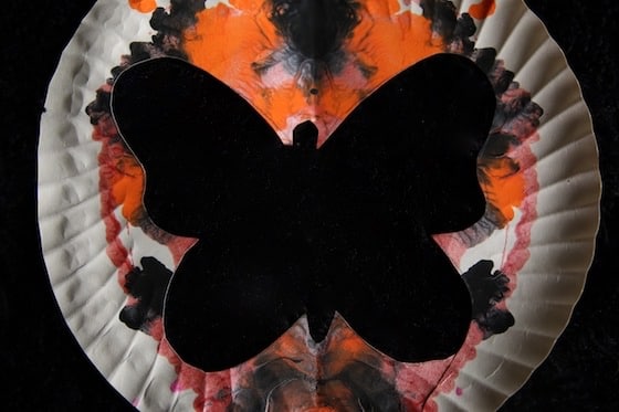 Butterfly silhouette with orange and black background