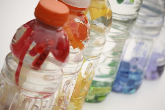 I spy (or discovery) bottles lined up in rainbow order