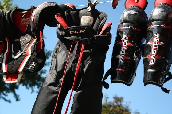 chest protector, pants and shin=guards drying on clothesline