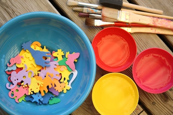 bowl of foam shapes, bowls of water and paintbrushes