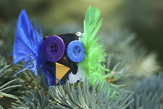 black halloween owl with blue and green feathers