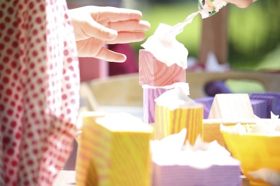 toddler spreading shaving cream on a foam block