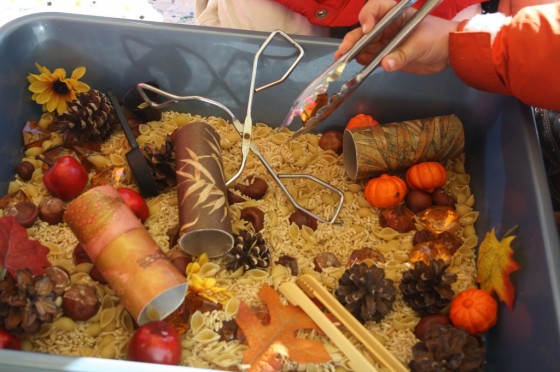 Kids playing in fall sensory bin 