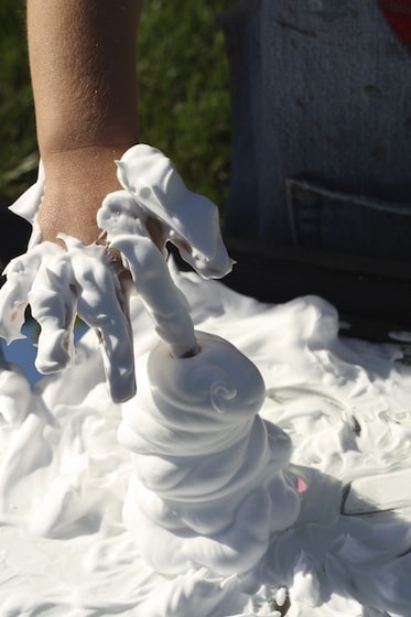 poking their fingers into a pile of shaving cream