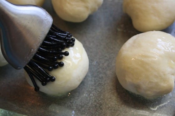 close up of bun being brushed with butter