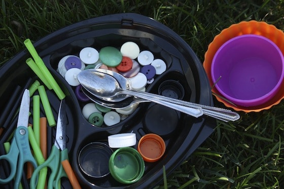 tools and items of interest for playing in a bowl of sand