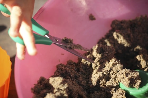 working on scissor skills while playing with sand