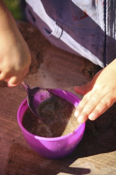 a spoon and a cup of sand