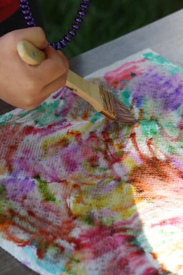 brushing water on to a marker-covered paper towel