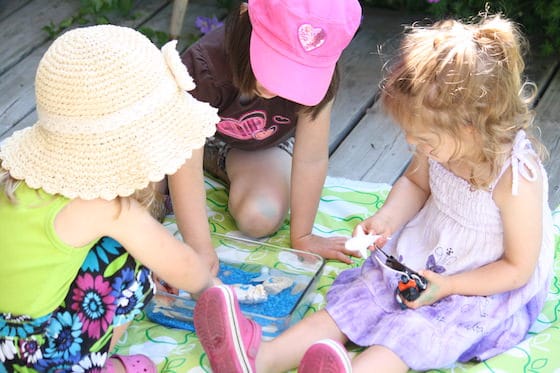 preschoolers playing with small world ocean bin