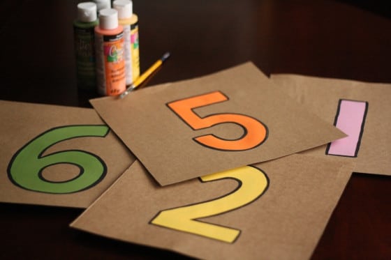 cardboard squares with numbers painted on them