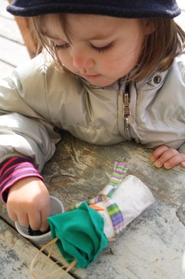 child gluing eyes on her snowman craft