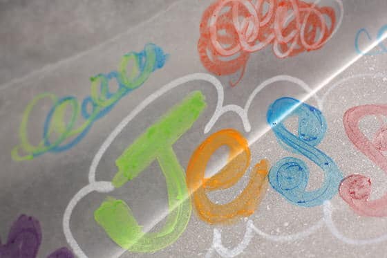 name drawn on hot baking sheet with melted crayons