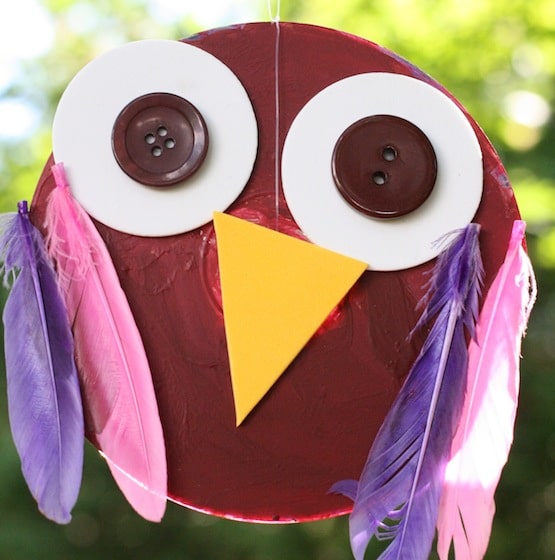 cd owl ornament hanging in a tree