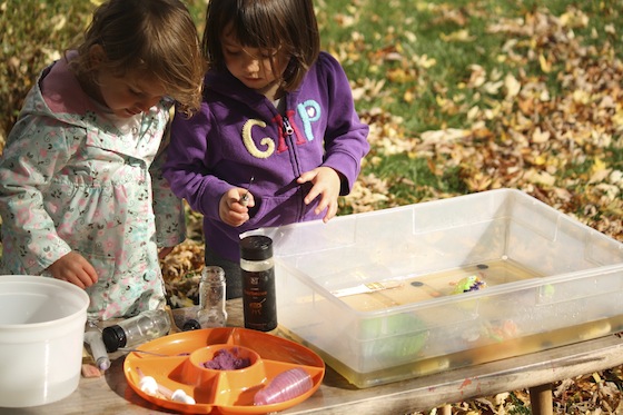 kids working together to melt ice with water using science