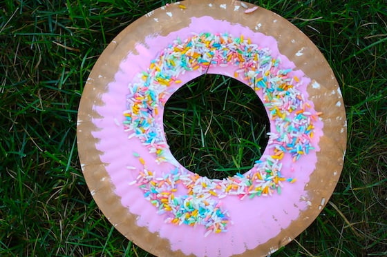 finished paper plate donut with icing and sprinkles