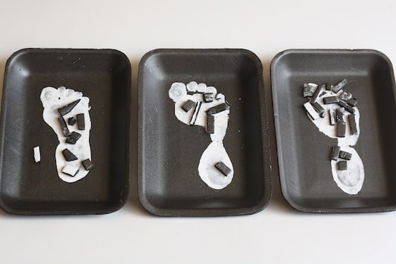 3 white painted footprints on styrofoam meat trays