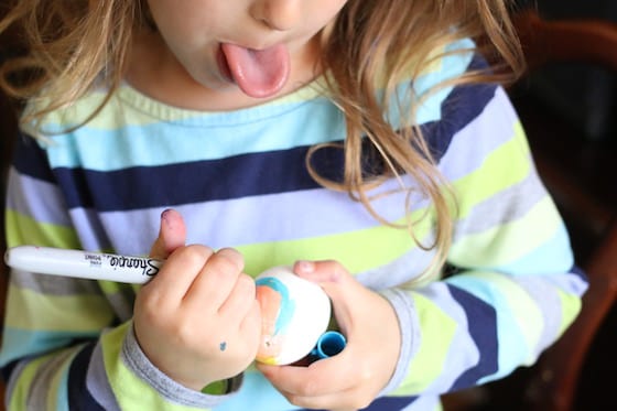 Preschooler colouring Easter Egg with Sharpies