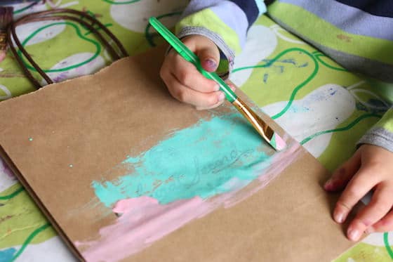 child painting paper bag