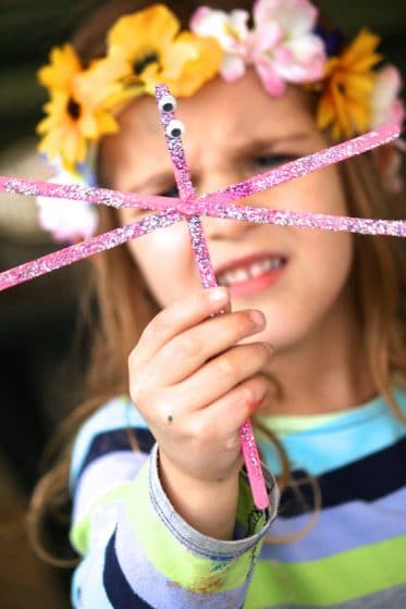 child holding dragonfly craft