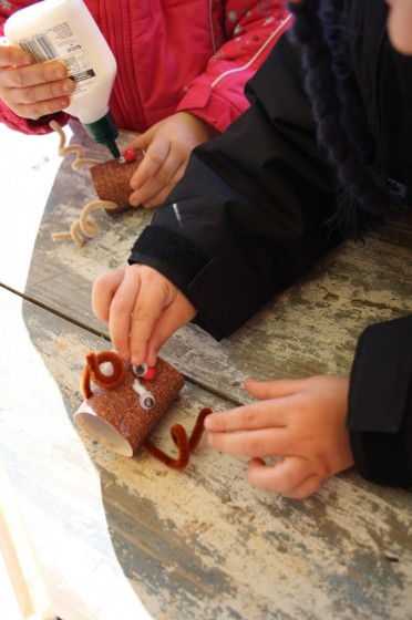 preschoolers gluing eyes on their ornaments