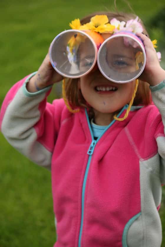 child looking through pringles cans