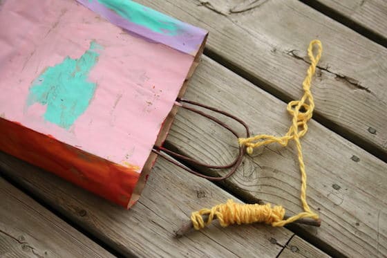 Stick, yarn and painted paper gift bag