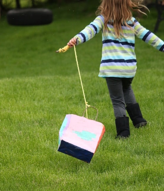 child running with homemade kite