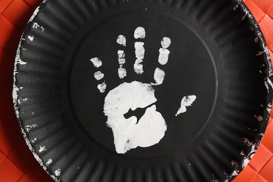 white handprint on paper plate