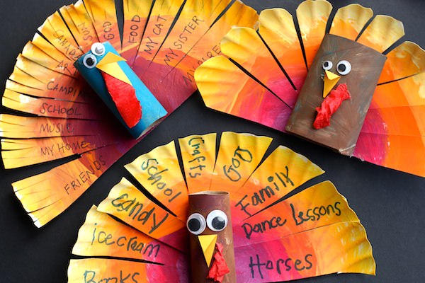 3 Paper Plate and cardboard roll turkeys displayed on back backdrop