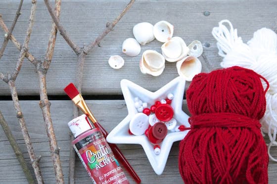 Yarn, buttons, sticks, paint and shells laid out on deck