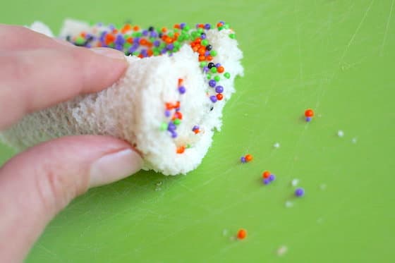 Rolling bread, butter and sprinkles into spirals