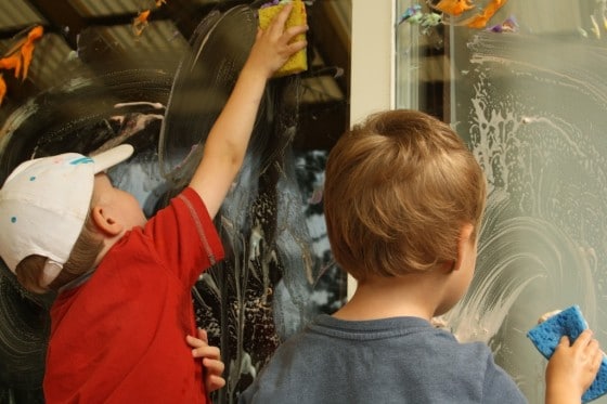 preschoolers washing sliding glass doors