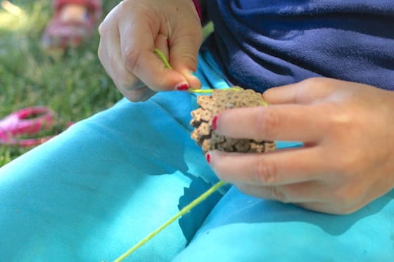 wrapping yarn around a pinecone