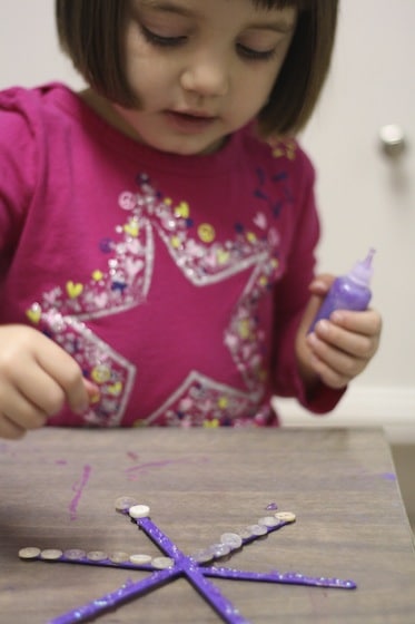 gluing buttons on snowflake ornaments