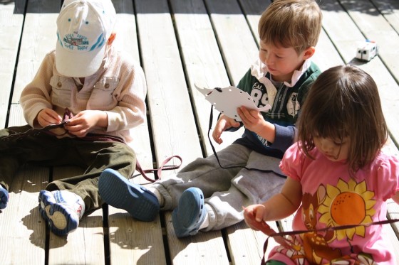 toddlers using homemade lacing cards