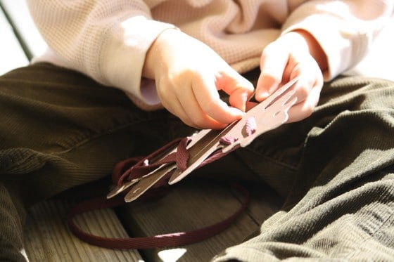 Child using homemade fall leaf lacing card