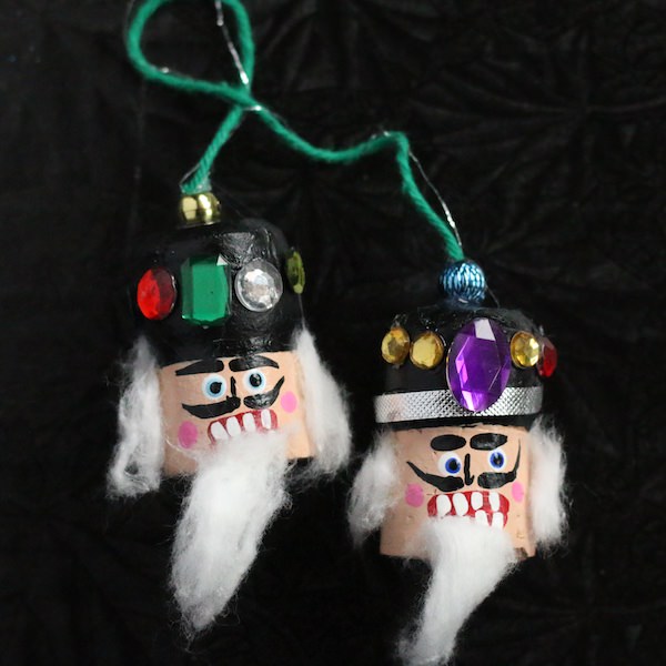 two nutcracker cork heads attached with string